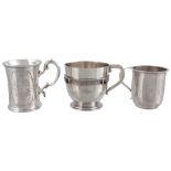 Three silver christening mugs,   comprising: a cup shape example by The Goldsmiths  &  Silversmiths