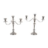 A pair of American weighted silver coloured three light candelabra by Cartier, stamped marks, in the