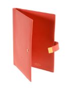 Smythson, a coral leather travel wallet,   with a gilt brass fold over clip, the interior with
