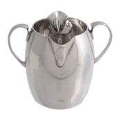 An Irish silver double lipped and double spoutted swollen cream jug by Wakely  &  Wheeler,   Dublin