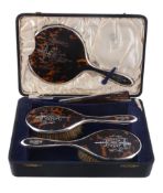 A cased silver mounted and tortoiseshell three piece dressing table set by S. Blanckensee  &  Sons