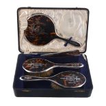 A cased silver mounted and tortoiseshell three piece dressing table set by S. Blanckensee  &  Sons