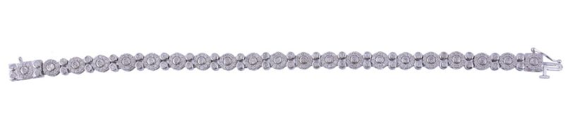 A diamond bracelet,   the bracelet with clusters of brilliant cut diamonds interspaced with pairs