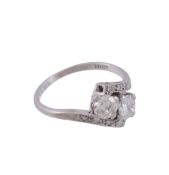 A two stone diamond ring,   the crossover ring with two brilliant cut diamonds in claw settings,