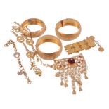 A collection of gold coloured jewellery  , to include three bangles;a red paste set pierced brooch,