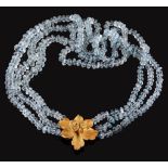 An aquamarine bead necklace,   composed of three strands of facetted aquamarine beads, to a