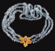 An aquamarine bead necklace,   composed of three strands of facetted aquamarine beads, to a