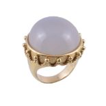 A milky chalcedony ring,   the circular shaped cabochon milky chalcedony collet set within a