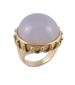 A milky chalcedony ring,   the circular shaped cabochon milky chalcedony collet set within a