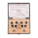 A diamond and onyx dress set,   circa 1930, the cufflinks with onyx panels each centred with a