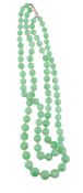 A two row jadeite bead necklace,   the graduated jadeite beads measuring 6mm to 10.5mm, 39cm long;