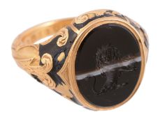 An early Victorian enamelled mourning ring,   the ring with an oval banded onyx panel carved with a