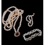 A cultured pearl necklace,   the three strands composed of uniform cultured pearls, to an oval
