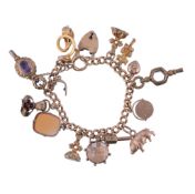 An 18 carat gold curb link charm bracelet,   the bracelet stamped 18, suspending various charms,
