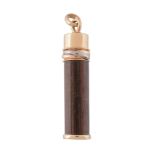 A Touch Wood pendant by Cartier,   the wooden baton topped with a three colour trinity band, signed