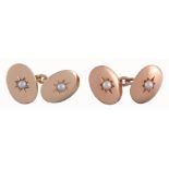 A pair of gold and pearl double sided cufflinks,   the oval panel set with a central pearl in a