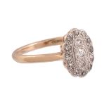 A diamond ring,   the oval shaped panel set with a central brilliant cut diamond within a surround