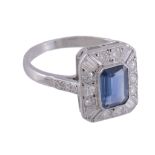 A sapphire and diamond ring,   the central rectangular shaped sapphire collet set within a surround