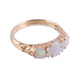 An 18 carat gold opal and diamond ring,   the central oval shaped opal claw set between brilliant