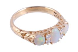 An 18 carat gold opal and diamond ring,   the central oval shaped opal claw set between brilliant