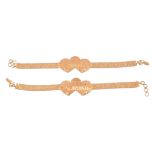 Two gold coloured bracelets  , each with a double heart shaped panel to a woven bracelet strap,