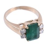 An emerald and diamond ring,   the central rectangular shaped emerald in a four claw setting