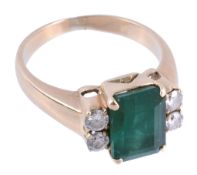 An emerald and diamond ring,   the central rectangular shaped emerald in a four claw setting