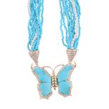 A turquoise and diamond butterfly pendant,   the butterfly with carved turquoise wings within a