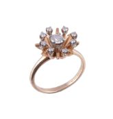 A diamond cluster dress ring by Brogan  , the central diamond, estimated to weigh 0.40 carats,