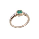 An emerald and diamond ring,   the central square shaped emerald collet set between square shaped