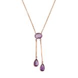 An amethyst pendant,   the oval shaped amethyst in a collet setting suspending two pear shaped