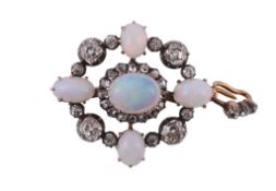 An opal and diamond brooch/pendant,   the central oval cabochon opal claw set within a surround of