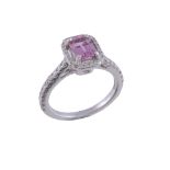 A diamond and pink sapphire cluster ring  , the step cut pink sapphire with canted corners, within
