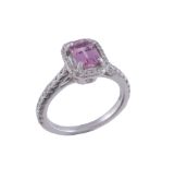 A diamond and pink sapphire cluster ring  , the step cut pink sapphire with canted corners, within