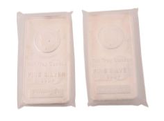 Two ten ounce silver coloured bars,   inset with a coin, stamped Ten Troy Ounces, Fine Silver,