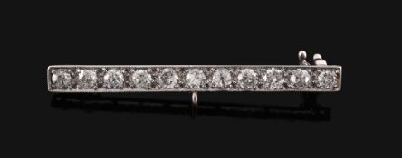 A diamond bar brooch,   the bar set along the line with old brilliant cut diamonds, 4.6cm long