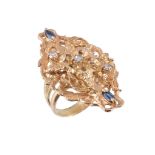 A sapphire and diamond dress ring,   the pierced panel with a central foliate design, set with an