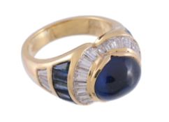 A sapphire and diamond bombe ring,   the central oval cabochon sapphire collet set within a