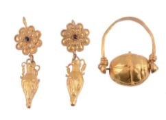 A pair of Roman style ear pendents  , the flower head pediments with a central cabochon garnet with