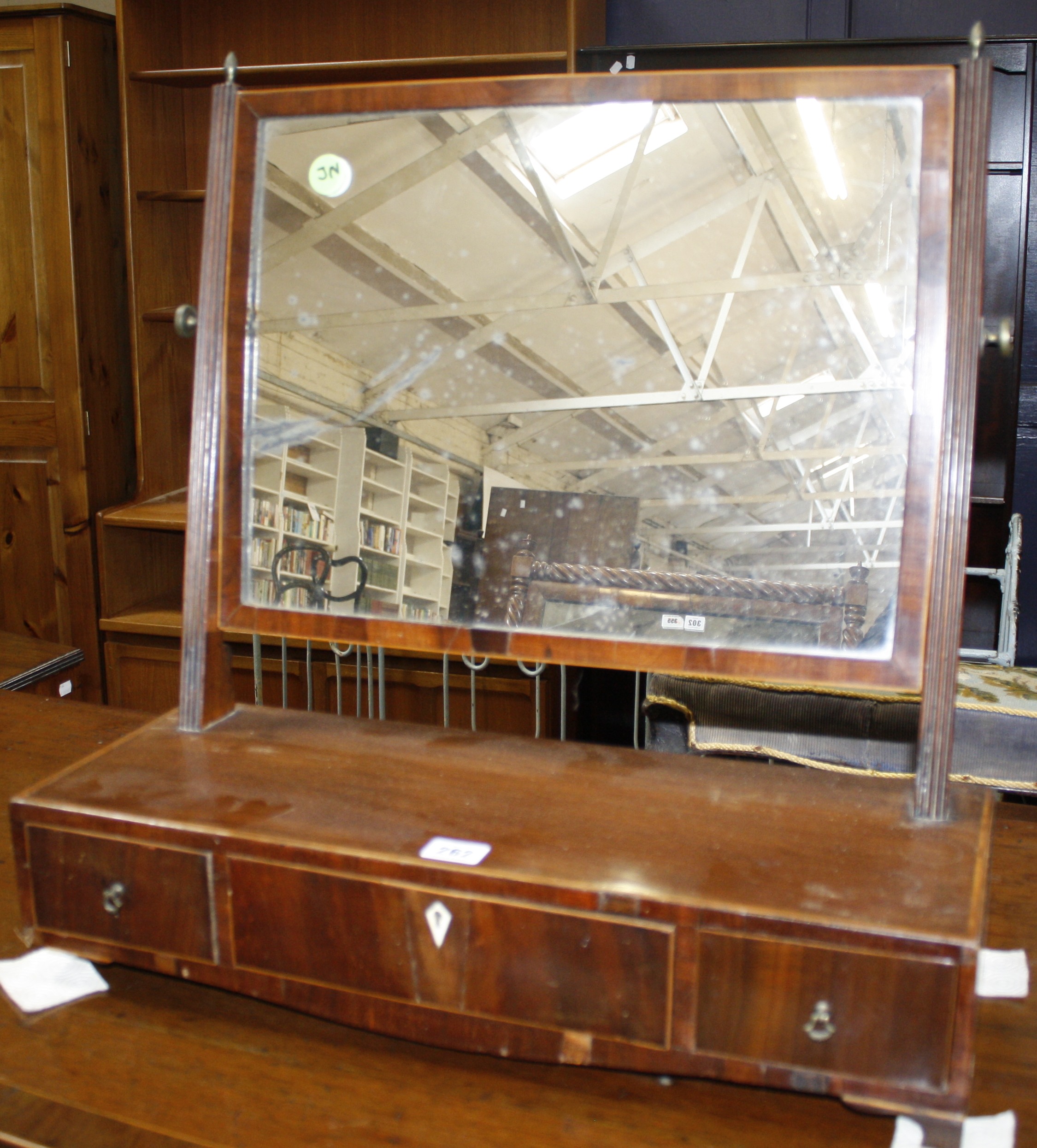 A George III mahogany swing frame dressing table mirror, raised on flat front base fitted with three