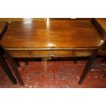 A George III and later mahogany folding tea table with angled corners and a frieze drawer on