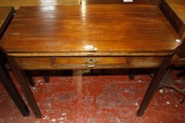 A George III and later mahogany folding tea table with angled corners and a frieze drawer on