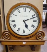 An oak circular wall clock, ex Chiswick Town Hall by G.W. Barker, 60cm wide