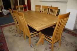 A modern oak kitchen dining table on X-frame supports 210cm length, and a set of eight chairs
