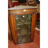 A mahogany corner cupboard with astragal glazed door enclosing painted shelves 86cm high, 55cm wide