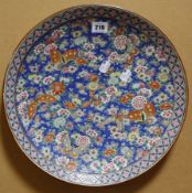 An Oriental charger, decorated with flowers and butterflies.