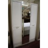 A modern white bedroom suite, comprising of two wardrobes and two chests of drawers