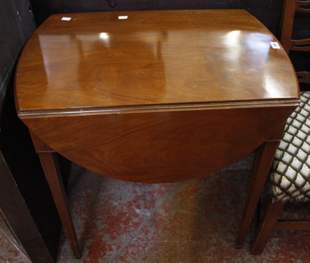 A mahogany oval pembroke table