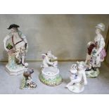 A pair of porcelain figures of male and female gardeners, a putti figure, a cherub and a scent