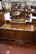 An Edwardian mahogany dressing table and a matching bedside cupboard